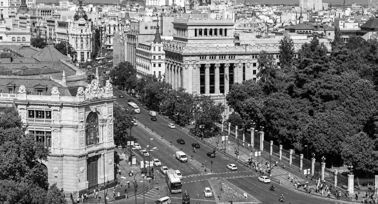 Madrid from the Palacio de Cibeles: Calle de Alcalá climbing past the Banco de España, with the city beyond. Black and white.